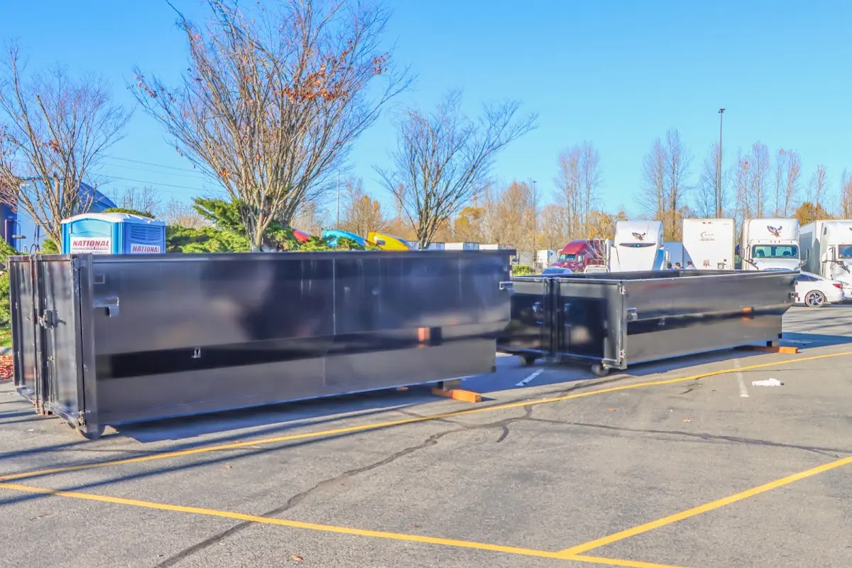 Professional dumpster rental service with roll-off container on residential driveway in Hoover